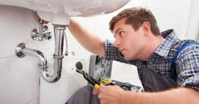 plumber  working under sink
